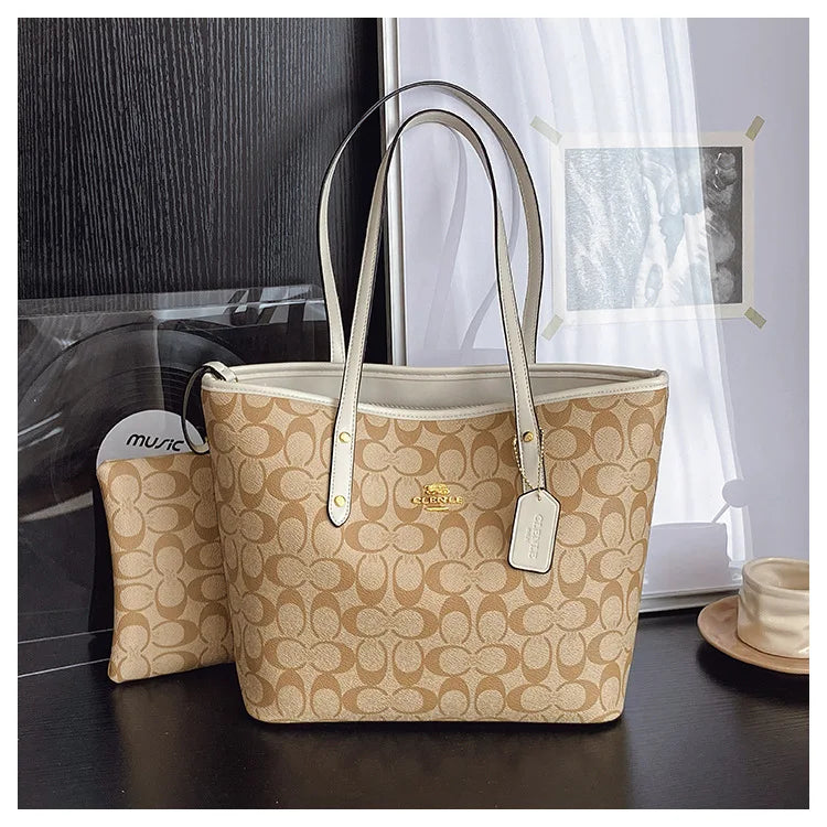 The Signature Tote featuring an elegant monogram pattern and matching pouch, perfect for stylish everyday use.