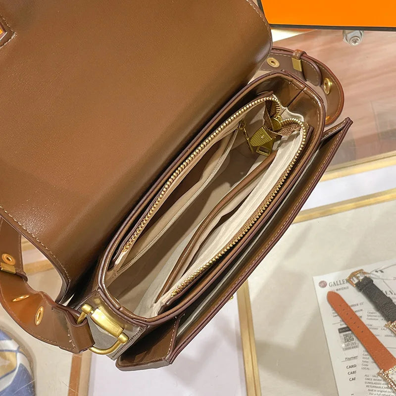 Interior view of the Horsebit Crossbody – Structured Gold Horsebit Bag showcasing its spacious compartments and elegant design.