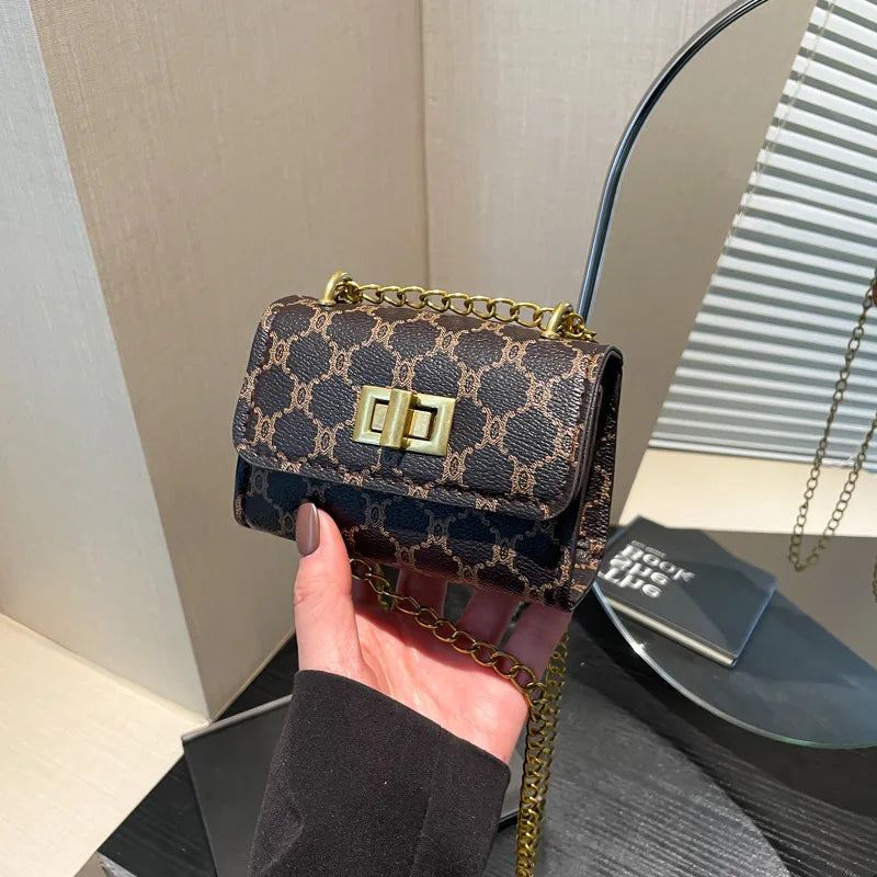 The Mini – Compact Women's Mini Handbag featuring a stylish design and chain strap, perfect for effortless everyday use.