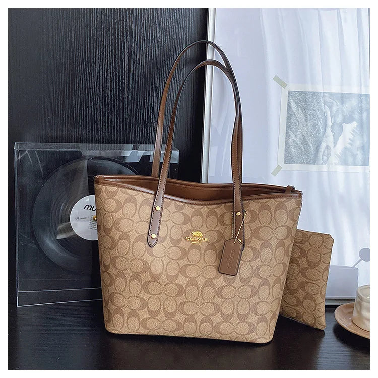 The Signature Tote – Monogram Tote with matching pouch, featuring elegant all-over pattern and leather trim.